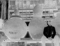 Unknown person sitting in the room of the Warehouse of Local Antiquities with clay barrels, or pithoi